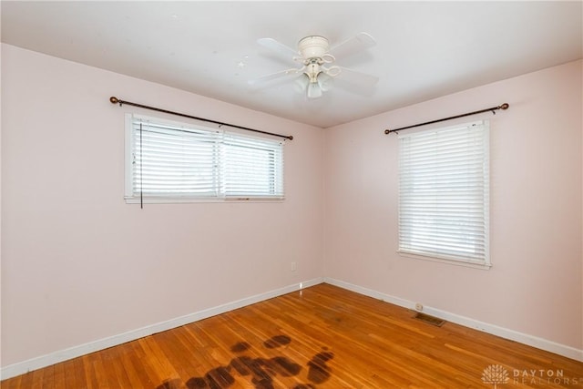 unfurnished room with ceiling fan and hardwood / wood-style floors