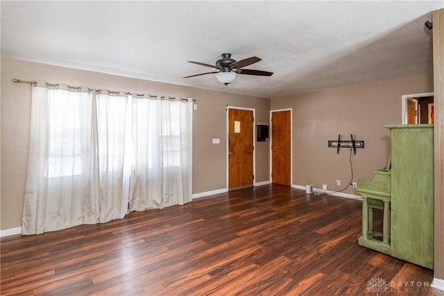 unfurnished room with dark hardwood / wood-style flooring and ceiling fan