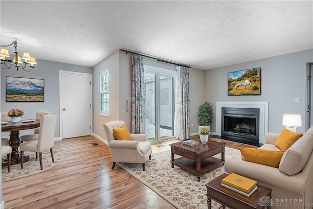 living room featuring light hardwood / wood-style flooring and a chandelier