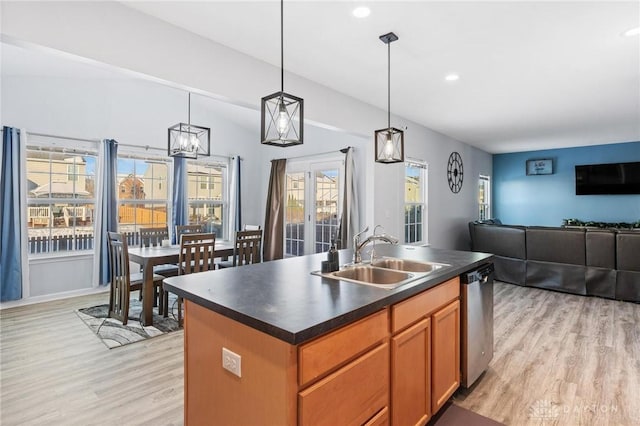 kitchen featuring sink, decorative light fixtures, dishwasher, light hardwood / wood-style floors, and a kitchen island with sink