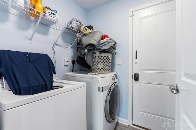 laundry area with washer and clothes dryer and hardwood / wood-style flooring