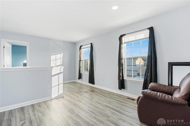 living area featuring light hardwood / wood-style floors and plenty of natural light