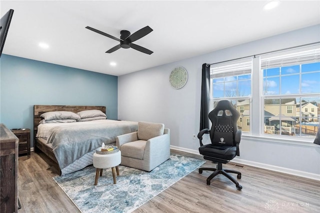 bedroom with ceiling fan and hardwood / wood-style floors