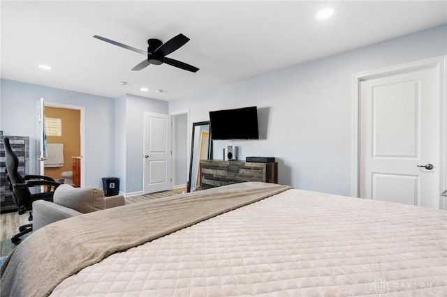 bedroom featuring ceiling fan, ensuite bathroom, and hardwood / wood-style floors