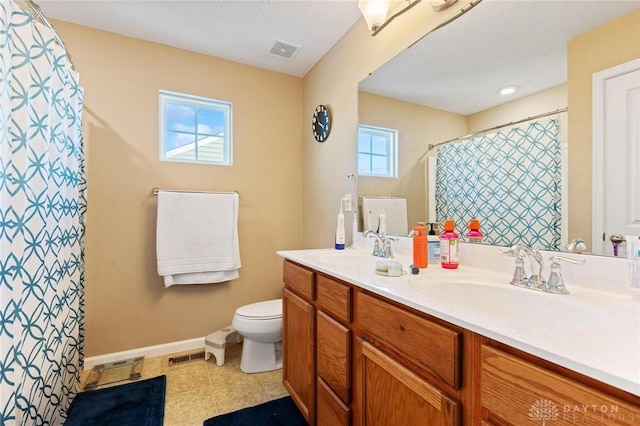 bathroom featuring walk in shower, vanity, and toilet