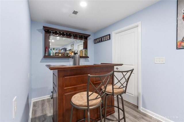 bar featuring hardwood / wood-style floors