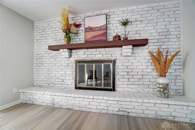 details featuring wood-type flooring and a brick fireplace