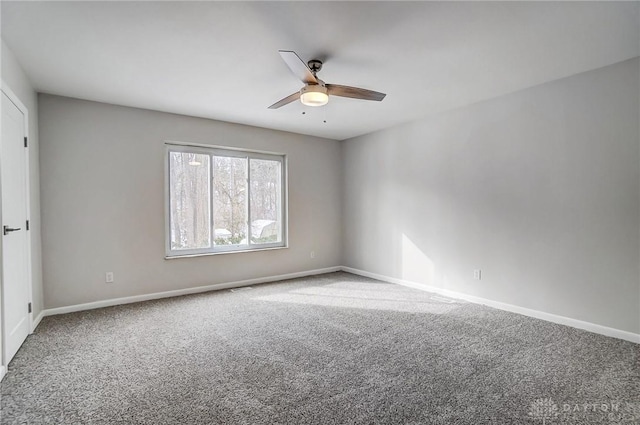 carpeted empty room featuring ceiling fan