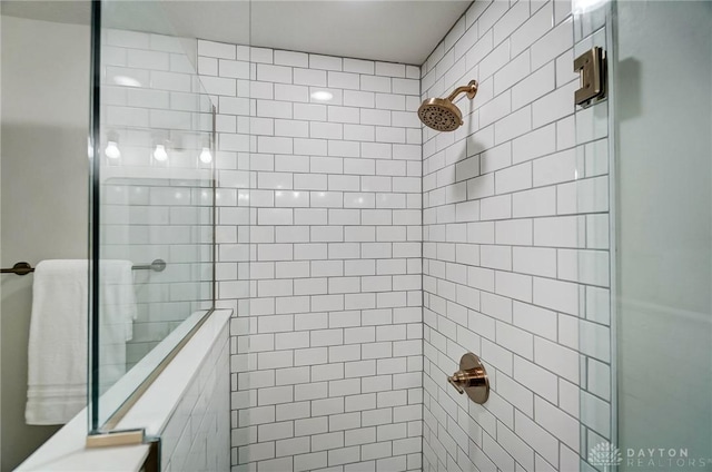 bathroom with tiled shower