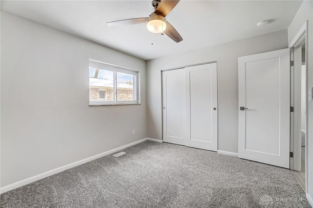 unfurnished bedroom with a closet, ceiling fan, and carpet