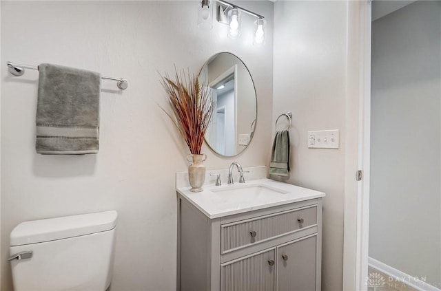 bathroom with toilet and vanity