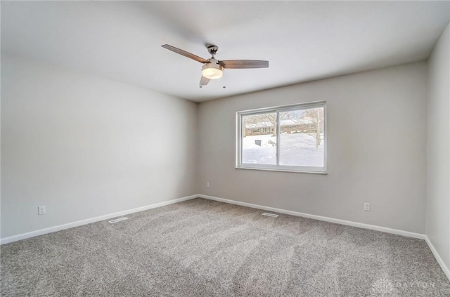 carpeted empty room featuring ceiling fan