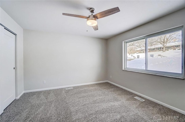 unfurnished room featuring ceiling fan and carpet floors