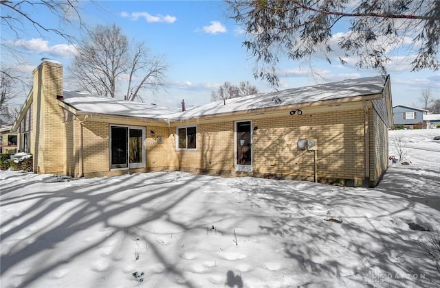 view of snow covered rear of property