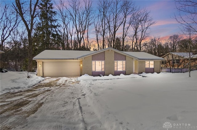 view of snow covered exterior featuring a garage