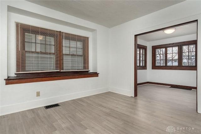 unfurnished room with light hardwood / wood-style floors