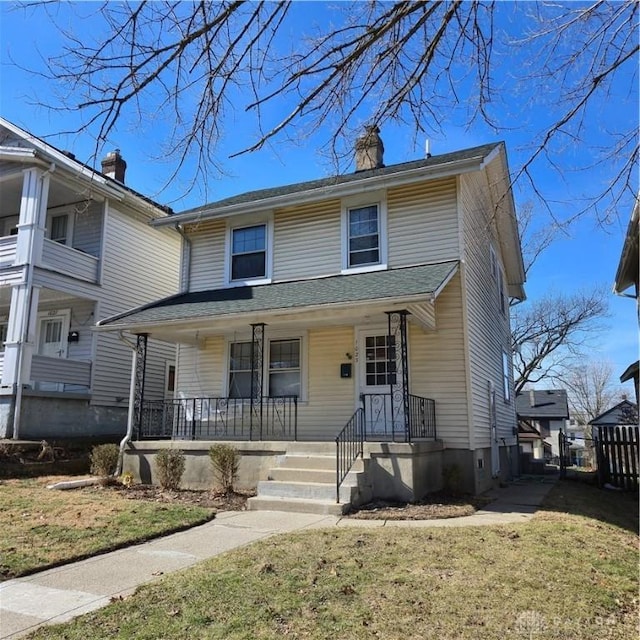 view of front of house with a porch and a front yard