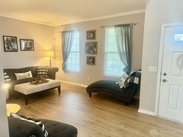 living area featuring crown molding and hardwood / wood-style floors