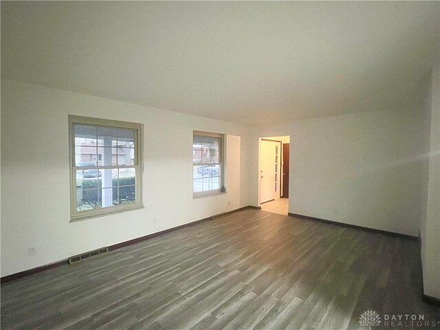 spare room with dark hardwood / wood-style floors