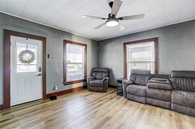 living room featuring ceiling fan and light hardwood / wood-style floors