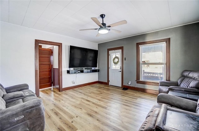 living room with light wood-type flooring and ceiling fan