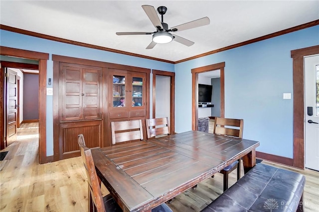 dining area with light wood-type flooring, ceiling fan, and crown molding