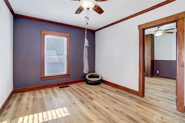 spare room featuring ceiling fan, light hardwood / wood-style flooring, and crown molding