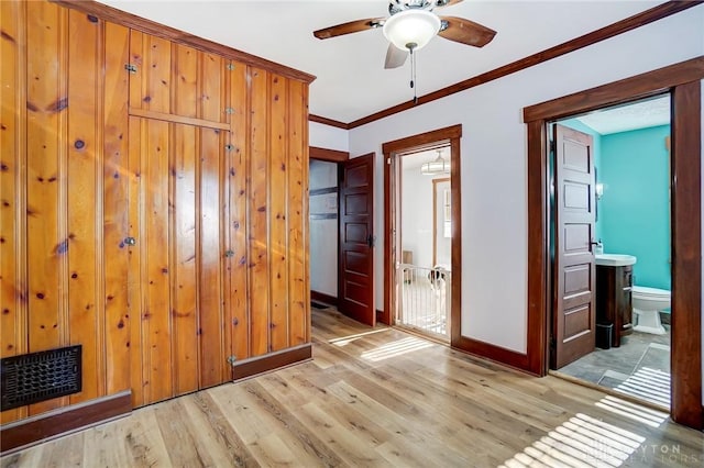 unfurnished room with light wood-type flooring, ceiling fan, and crown molding