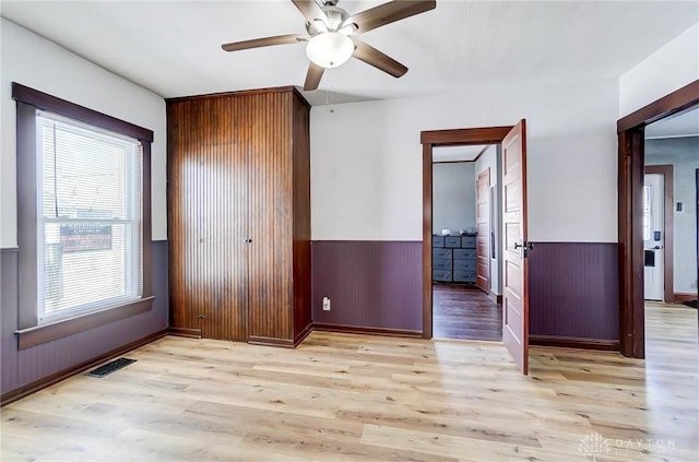 unfurnished bedroom featuring ceiling fan and light hardwood / wood-style floors