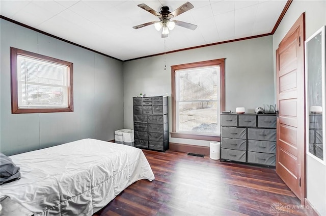 bedroom featuring ceiling fan, dark hardwood / wood-style flooring, and ornamental molding