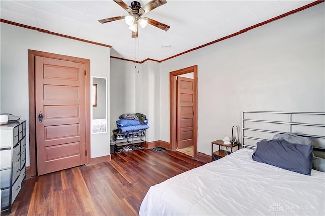 bedroom with ceiling fan, dark wood-type flooring, and crown molding