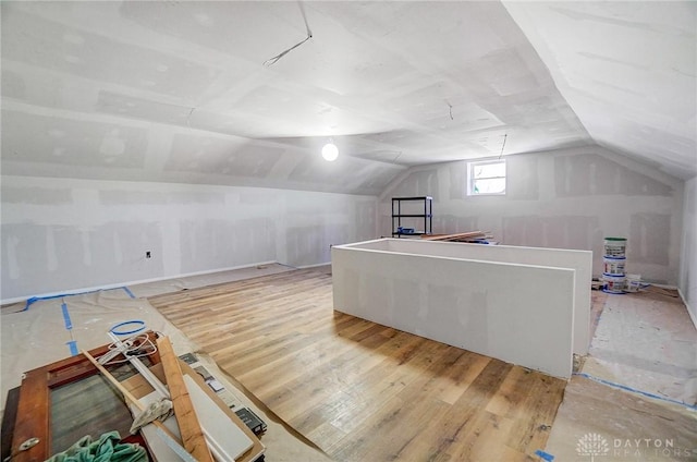 bonus room featuring vaulted ceiling and hardwood / wood-style flooring