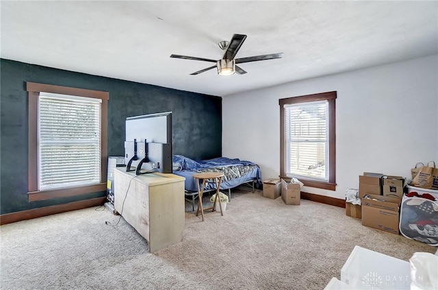 bedroom featuring ceiling fan and carpet