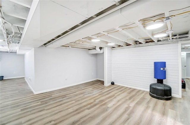 basement with light hardwood / wood-style floors