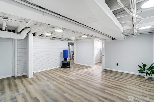 basement with hardwood / wood-style flooring