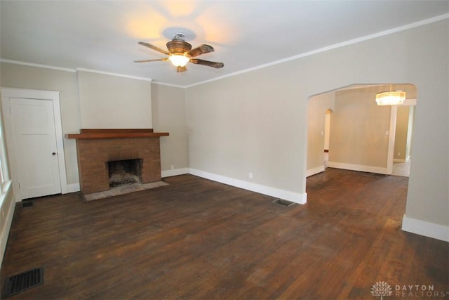 unfurnished living room with ornamental molding, arched walkways, visible vents, and wood finished floors