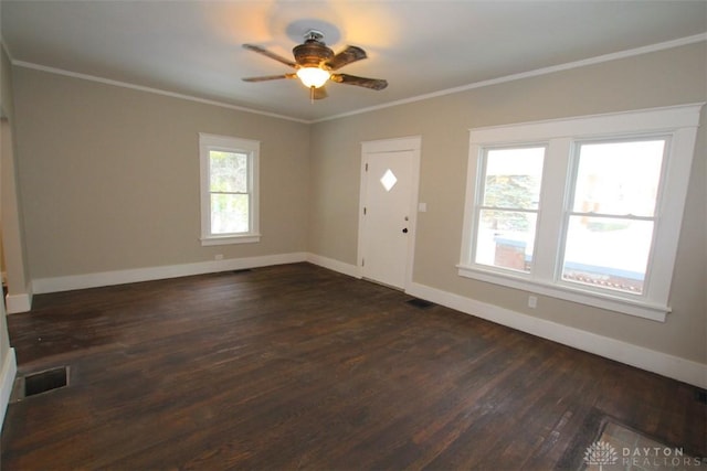 entryway featuring baseboards, dark wood-type flooring, visible vents, and crown molding