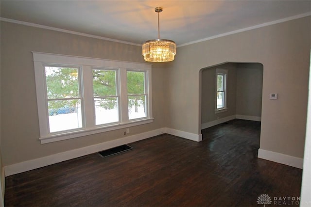 unfurnished room with baseboards, visible vents, dark wood finished floors, crown molding, and a notable chandelier