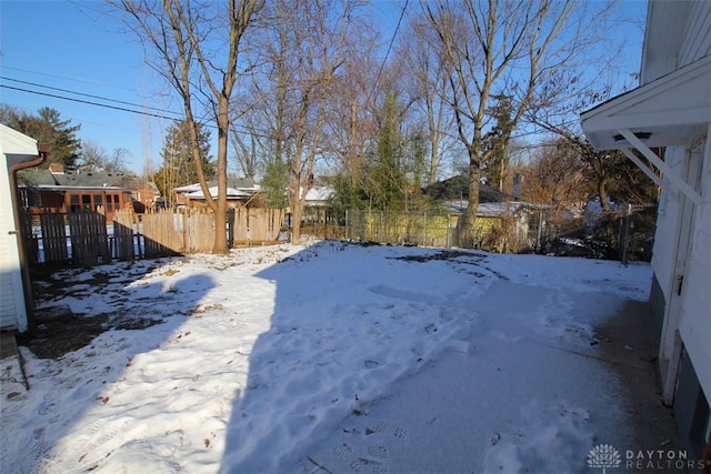 yard covered in snow with fence