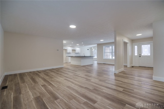 unfurnished living room featuring light wood-type flooring