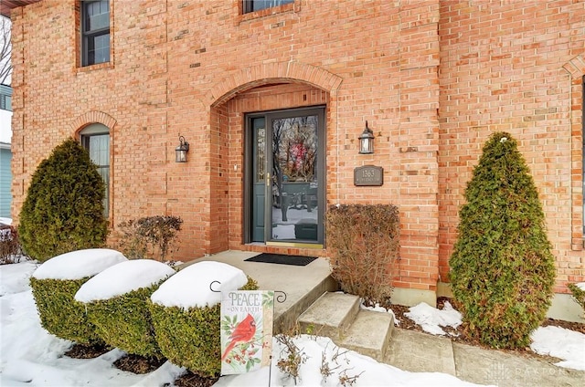 view of snow covered property entrance