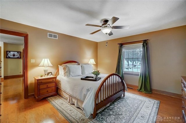 bedroom with ceiling fan and light hardwood / wood-style flooring