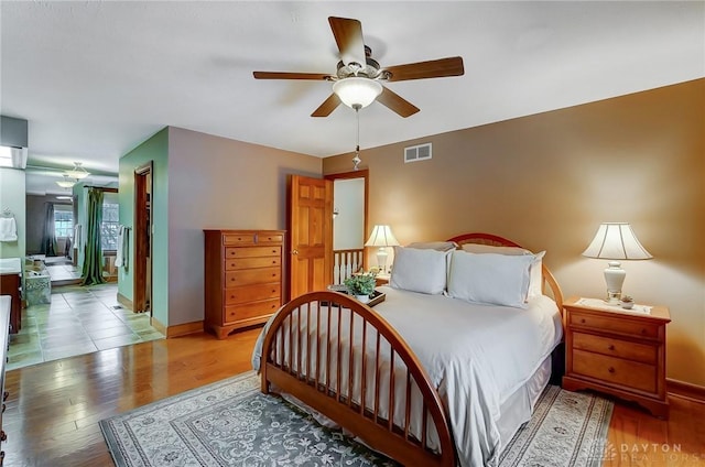 bedroom with ceiling fan and hardwood / wood-style floors