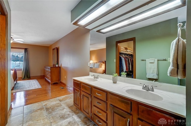 bathroom with hardwood / wood-style flooring, vanity, and ceiling fan