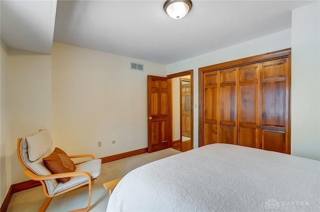 bedroom with a closet and light colored carpet