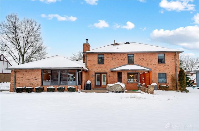 view of snow covered rear of property