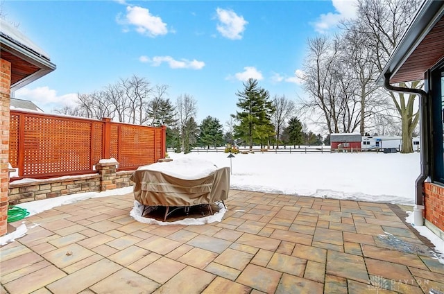 snow covered patio with area for grilling