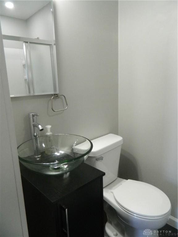 bathroom featuring toilet and vanity