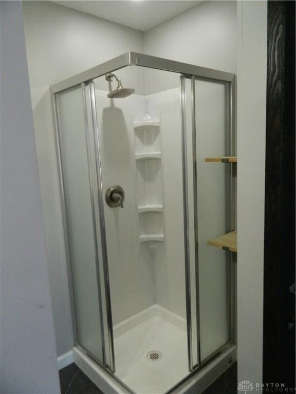 bathroom featuring walk in shower and tile patterned floors