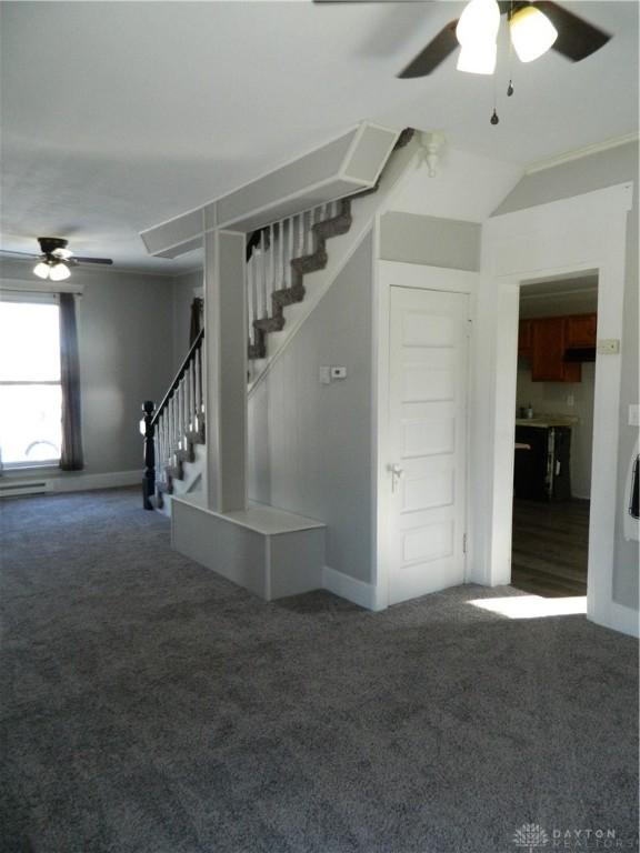 spare room featuring ceiling fan, carpet, and lofted ceiling